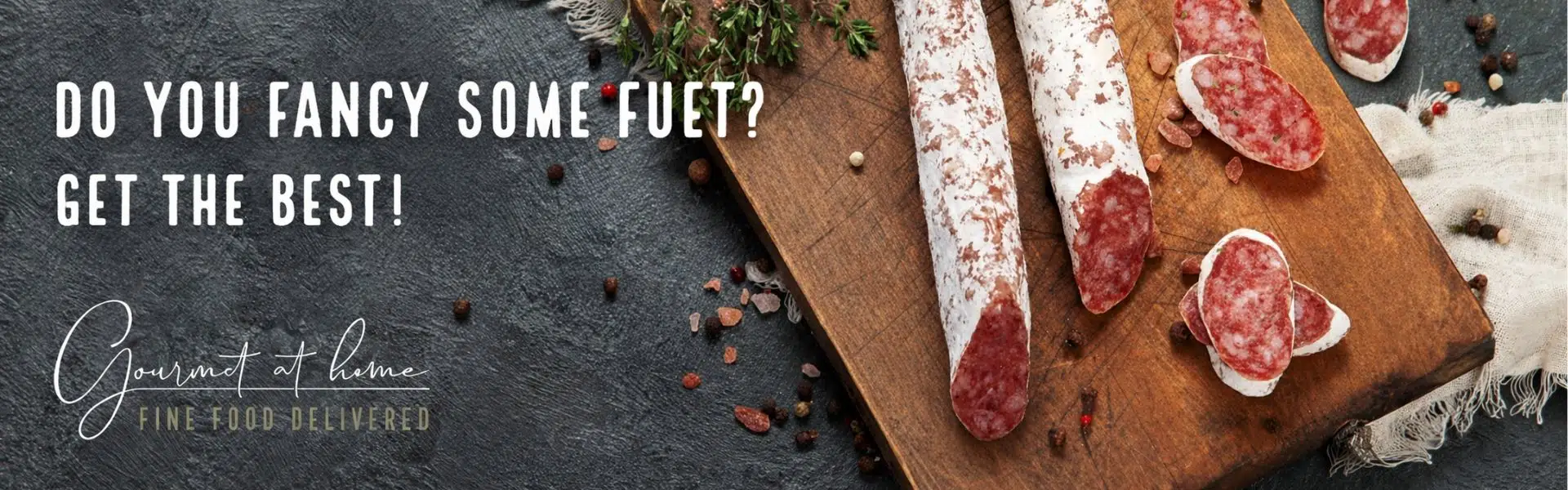 Traditional Spanish fuet cured sausage on rustic wooden board